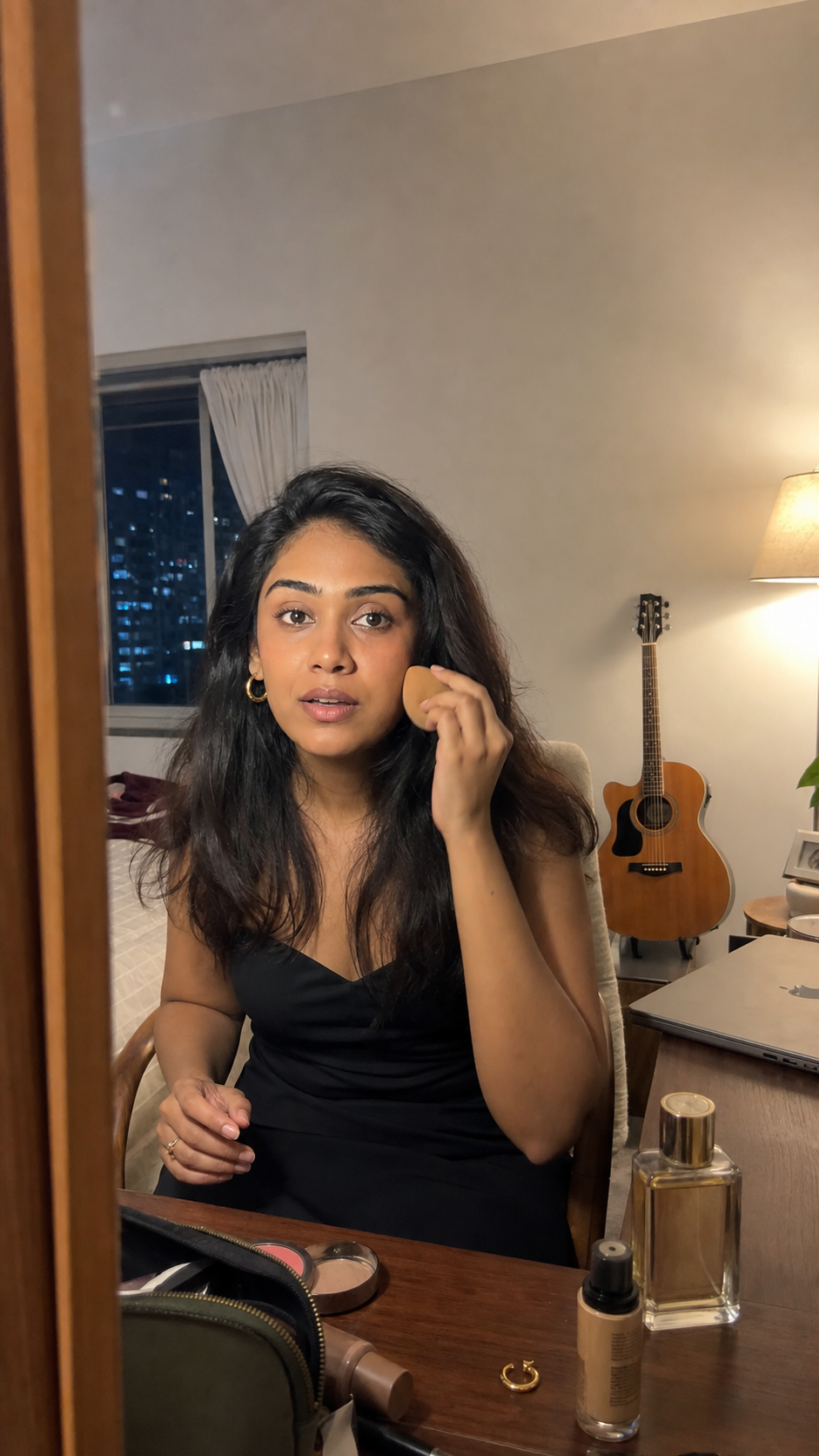 The same woman getting ready for dinner with her laptop closed and guitar behind her